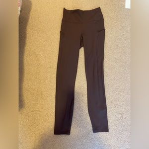 Purple/maroon Fabletics leggings with pockets.